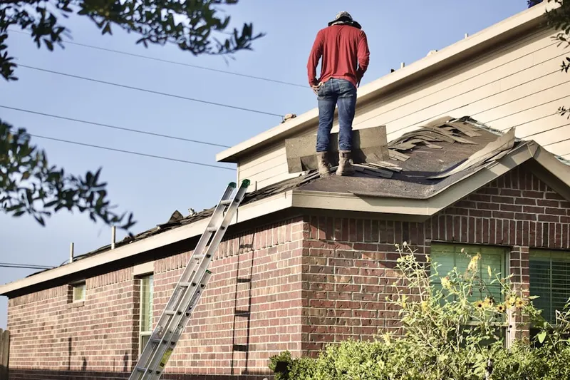Professional roofer working on a residential roof in Nassau Village